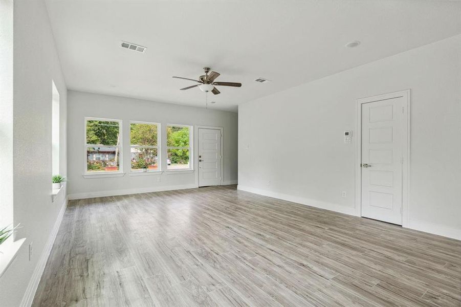 Unfurnished room with ceiling fan and light hardwood / wood-style flooring