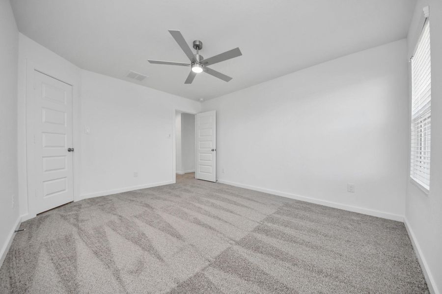 Generously sized secondary bedrooms featuring spacious closets, soft and inviting carpeting underfoot, large windows allowing plenty of natural light, and the added touch of privacy blinds for your personal retreat. Sample photo of completed home with similar floor plan. Actual colors and selections may vary.