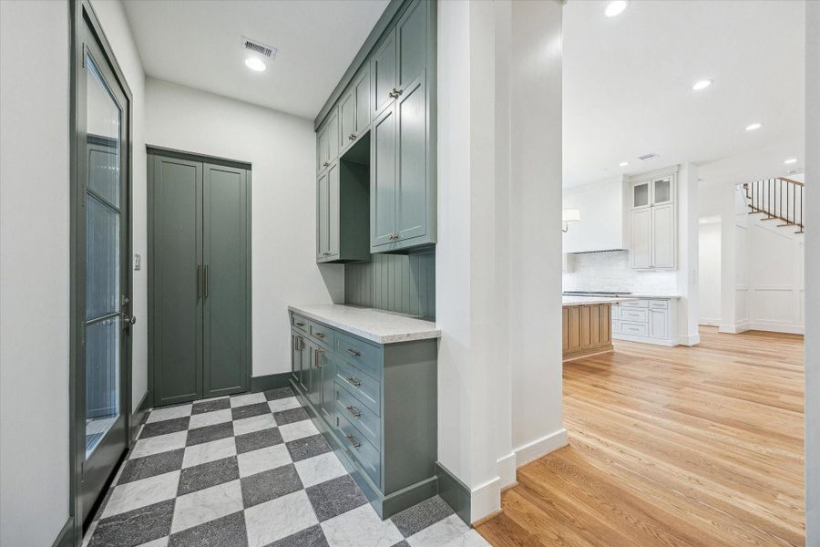 Side entrance from Portico into a great drop off storage area! Includes stackable washer/dryer hook ups, designer tile flooring & custom paint! Side entrance from Portico into a great drop off storage area! Includes stackable washer/dryer hook ups, designer tile flooring & custom paint!