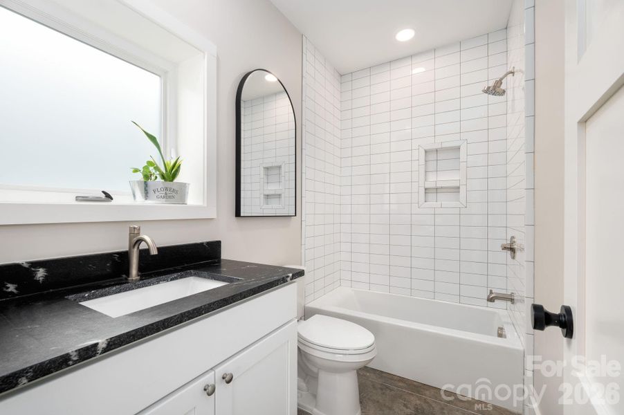 Full Bath with Leathered Granite Counter and Tiled Shower + Tub