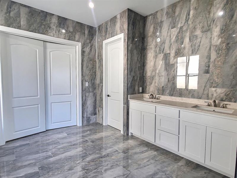 Bathroom with tile walls and vanity