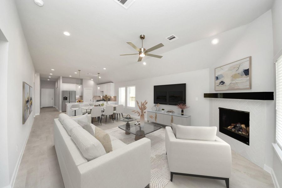 VS. Relax and unwind in this inviting family room, illuminated by abundant natural light streaming in through tall windows, complemented by high ceilings and stunning flooring. Stay comfortable year-round with the gentle breeze from the ceiling fan, creating the perfect atmosphere for family gatherings. Sample photo of completed home with similar floor plan. Actual colors and selections may vary.