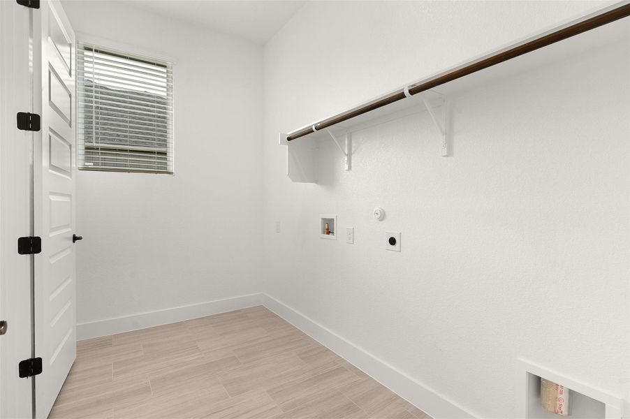 Laundry room featuring hookup for a gas dryer, electric dryer hookup, washer hookup, and light wood-style floors