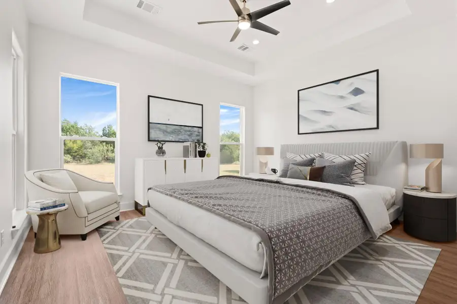 Bedroom with a raised ceiling, light wood-style flooring, ceiling fan, and recessed lighting Bedroom with a raised ceiling, light wood-style flooring, ceiling fan, and recessed lighting