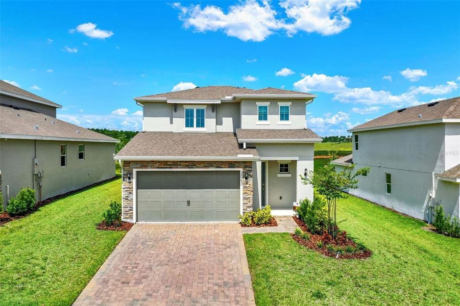 Front exterior of a new home in Hills of Minneola, Minneola, FL, highlighting curb appeal (Image 1). Front exterior of a new home in Hills of Minneola, Minneola, FL, highlighting curb appeal (Image 1).
