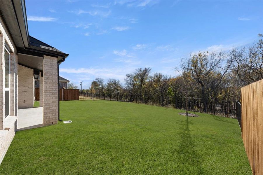Exterior details and patio area of a home in Valencia on The Lake, Little Elm (Image 22).