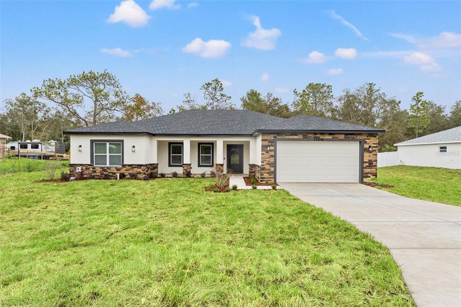 Front exterior of a new home in , Weeki Wachee, FL, highlighting curb appeal (Image 2). Front exterior of a new home in , Weeki Wachee, FL, highlighting curb appeal (Image 2).