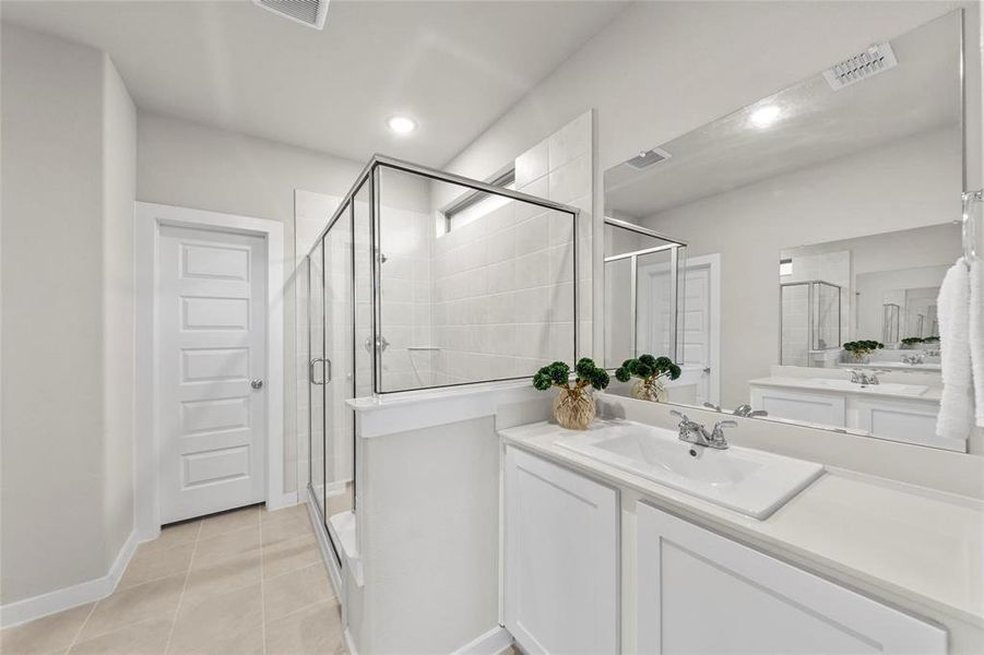 Full bathroom with a stall shower, vanity, light tile patterned floors, and recessed lighting Full bathroom with a stall shower, vanity, light tile patterned floors, and recessed lighting