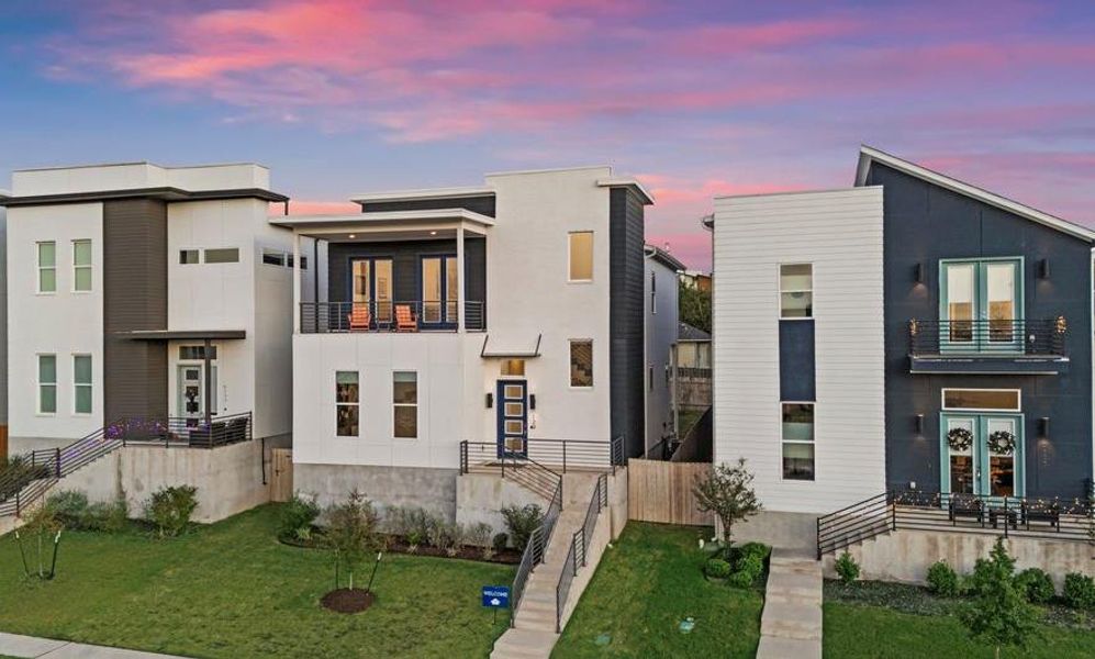 Modern home with a balcony and a front yard