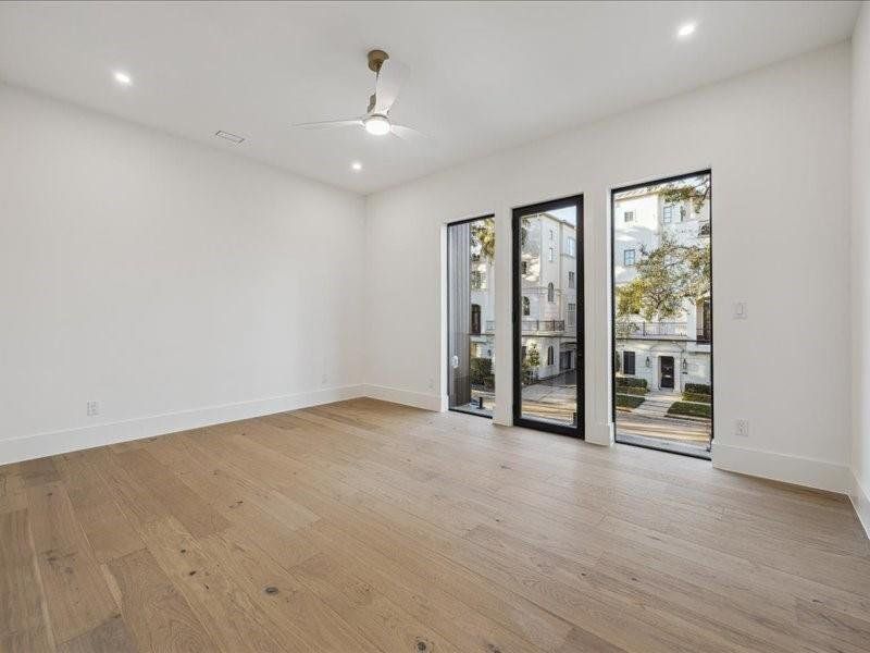 A spacious secondary bedroom at the front of the home features a beautiful balcony and a private en-suite bathroom.