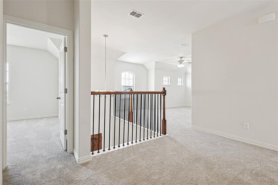 Hall featuring light colored carpet and baseboards Hall featuring light colored carpet and baseboards