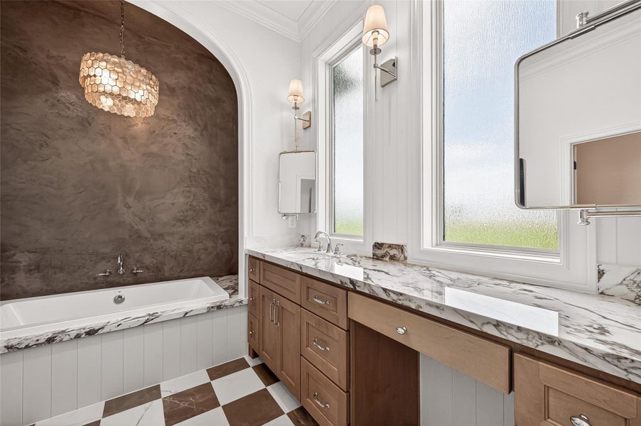 Porcelain countertops in this luxurious primary bath