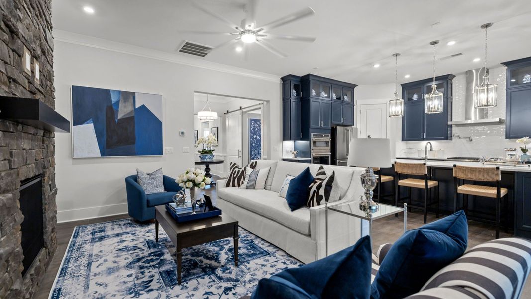 The Adventurer Plan by DBR Homes modern living area with large stone fireplace in Fort Mill, SC.