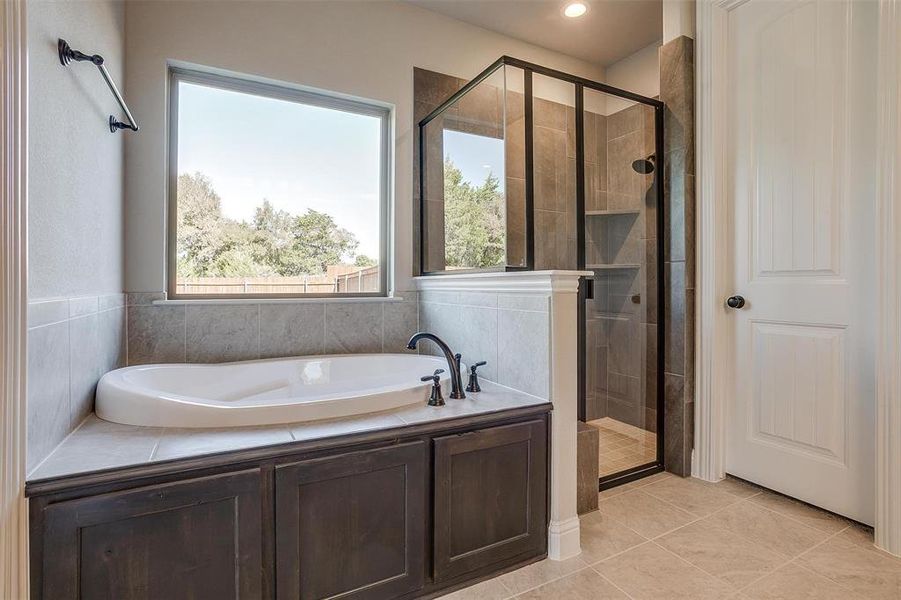 Bathroom with tile patterned floors and separate shower and tub