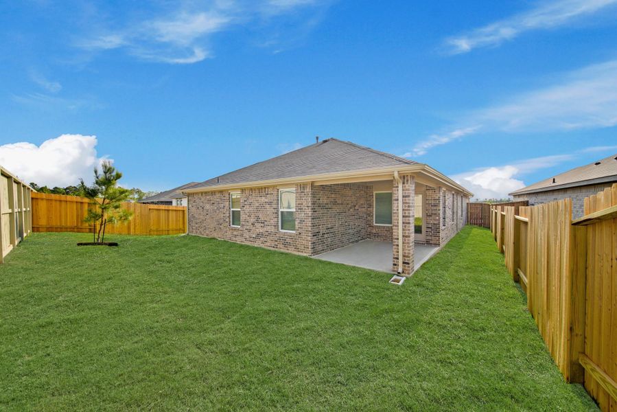 Exterior details and patio area of a home in Harrington Trails at The Canopies, Splendora (Image 4).