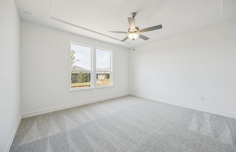 Spacious owner's suite highlighted by large windows and an exquisite tray ceiling *Real home pictured Spacious owner's suite highlighted by large windows and an exquisite tray ceiling *Real home pictured