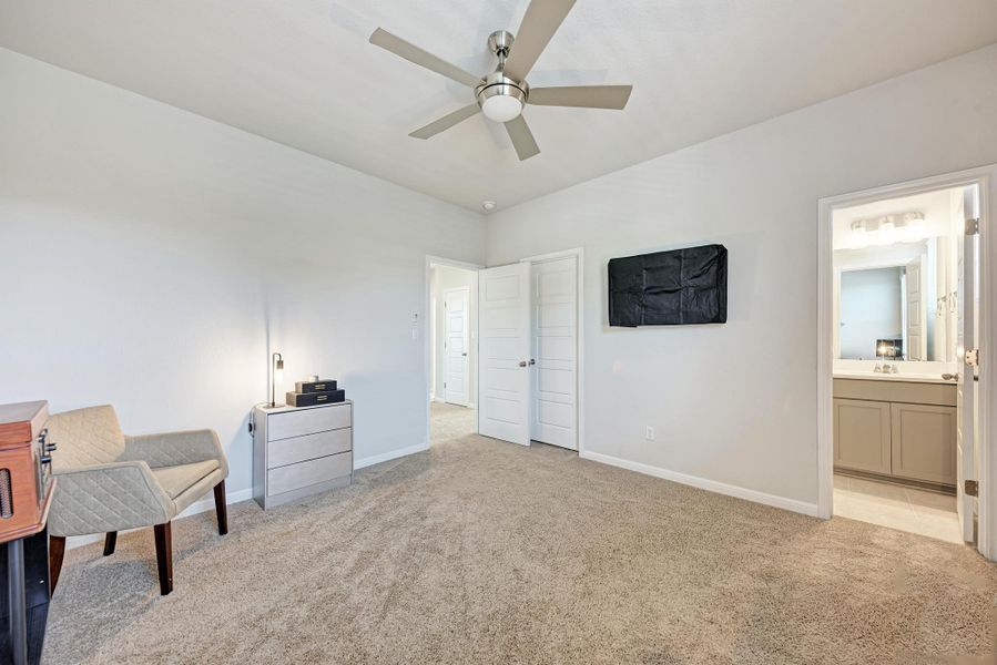 Sitting room featuring light colored carpet and a ceiling fan