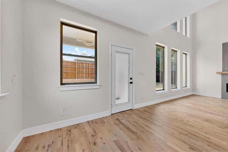 Foyer entrance featuring light wood-style floors and a tiled fireplace Foyer entrance featuring light wood-style floors and a tiled fireplace