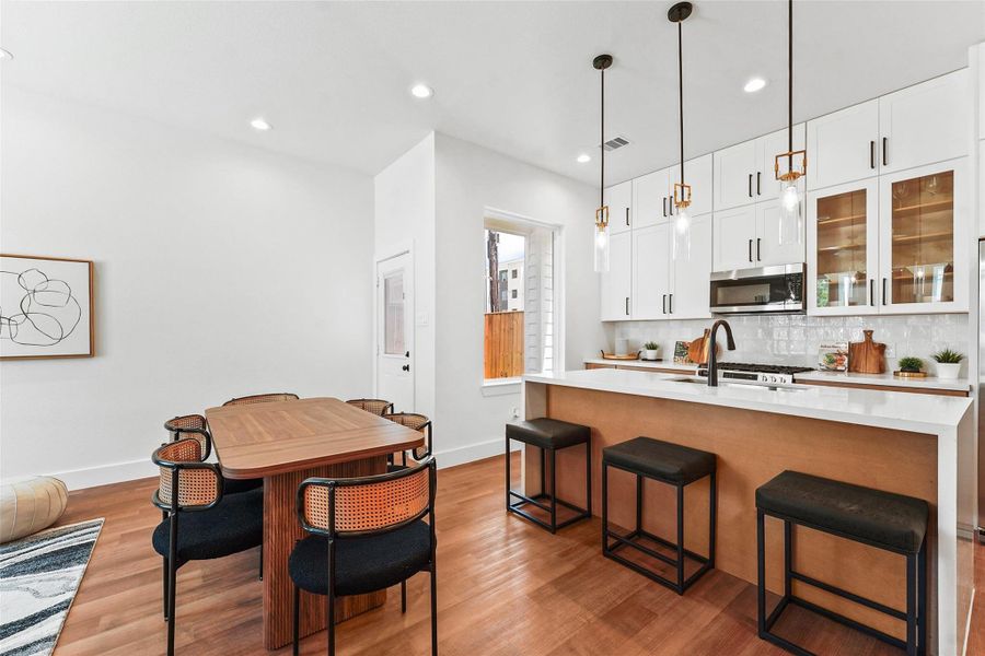 The dining area flows seamlessly into the cozy seating space, creating an inviting atmosphere for gatherings. The dining area flows seamlessly into the cozy seating space, creating an inviting atmosphere for gatherings.