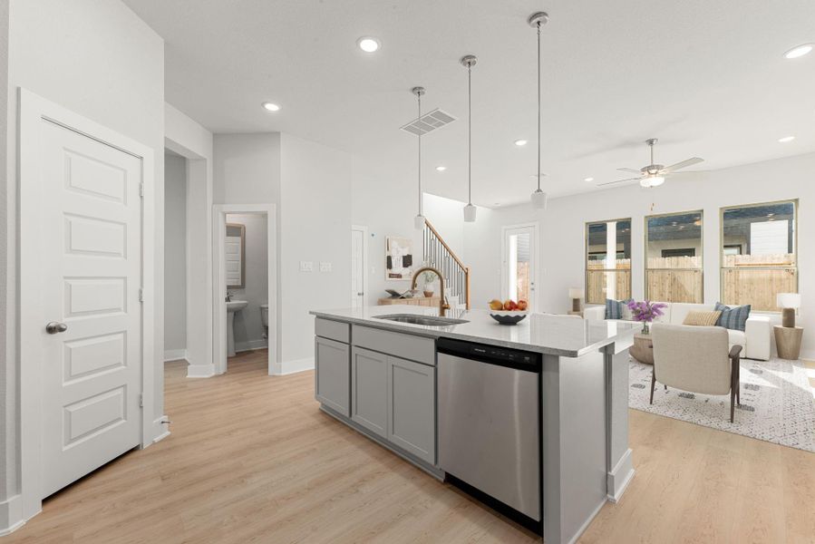 This sleek kitchen offers a modern aesthetic with quartz countertops, stainless steel appliances, and a large island with pendant lighting. Its open layout flows effortlessly into the living area, creating a bright and cohesive space designed for everyday living. This sleek kitchen offers a modern aesthetic with quartz countertops, stainless steel appliances, and a large island with pendant lighting. Its open layout flows effortlessly into the living area, creating a bright and cohesive space designed for everyday living.