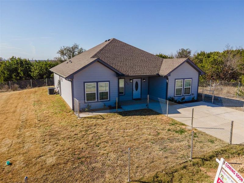 Ranch-style home featuring central AC and a front yard