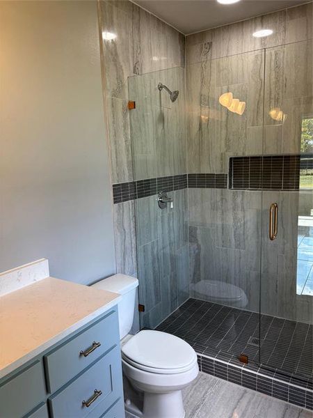 Full bathroom featuring a shower stall and vanity Full bathroom featuring a shower stall and vanity