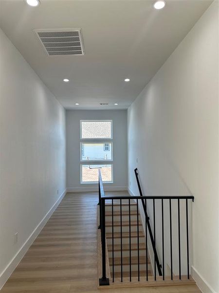 Stairs with hardwood / wood-style floors