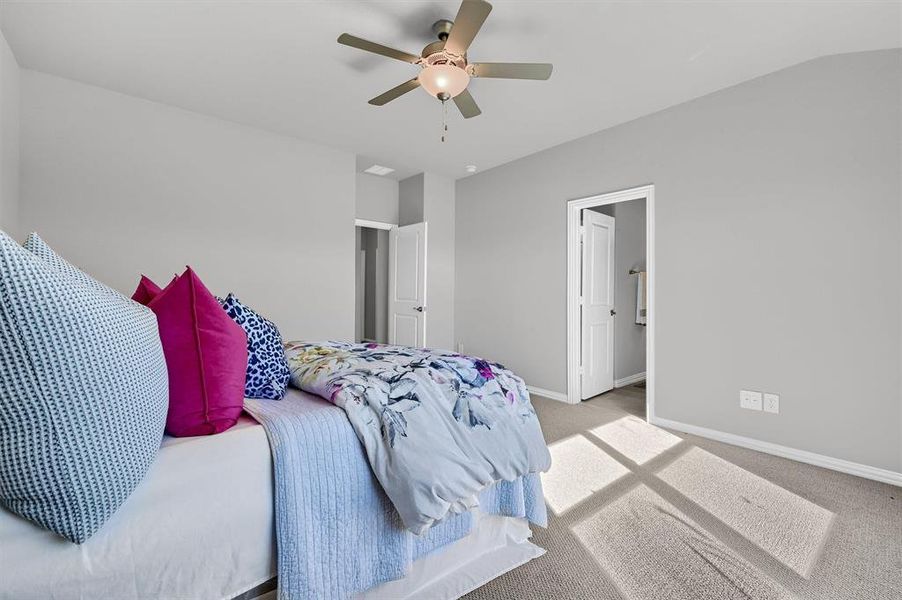 Carpeted bedroom featuring ceiling fan