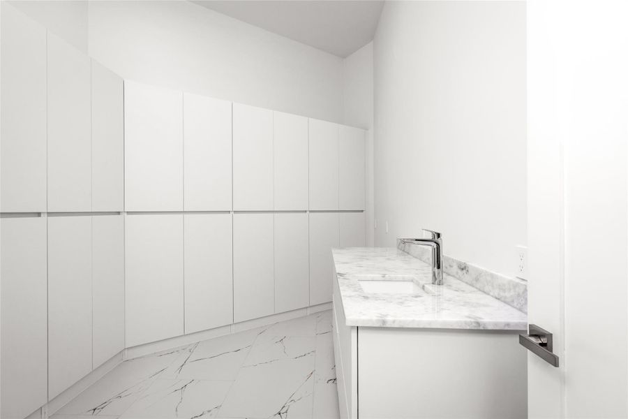 The oversized walk-in panty offers immense storage, plus and additional sink! The oversized walk-in panty offers immense storage, plus and additional sink!