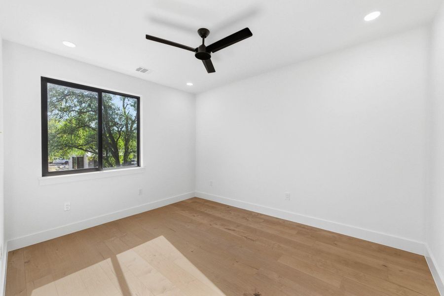 Additional secondary bedroom featuring light wood-style floors, ceiling fan, and recessed lighting