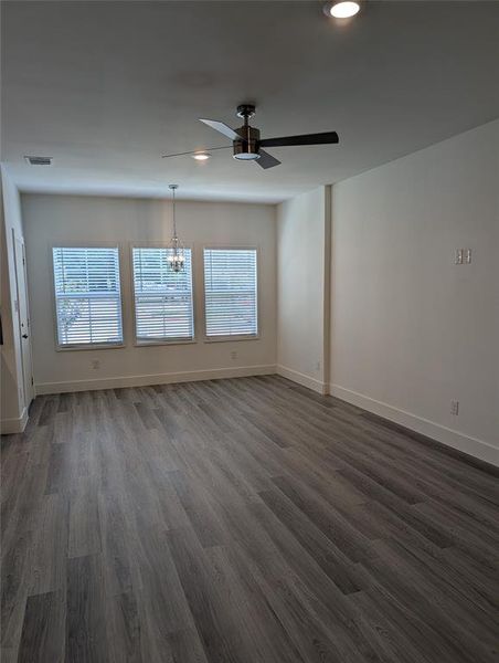 Unfurnished living room with healthy amount of natural light, ceiling fan