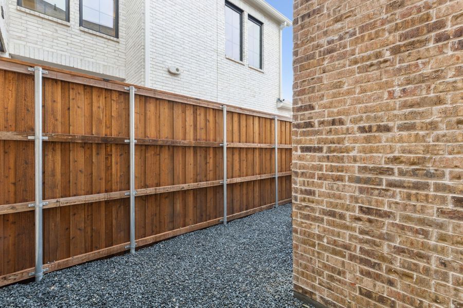Exterior details and patio area of a home in Newman Village Townhomes, Frisco (Image 26).