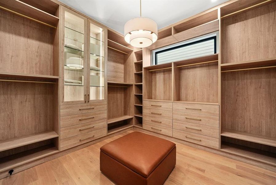Walk in closet featuring light wood-style flooring Walk in closet featuring light wood-style flooring