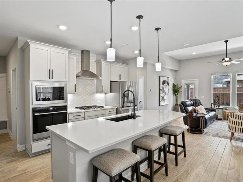 Quartz counters, pendant lights, and a gas cooktop—this kitchen’s got both looks and function. Everything you need, exactly where you want it—plus a view into the heart of the home. Quartz counters, pendant lights, and a gas cooktop—this kitchen’s got both looks and function. Everything you need, exactly where you want it—plus a view into the heart of the home.