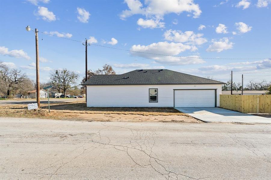 View of side of home featuring a garage