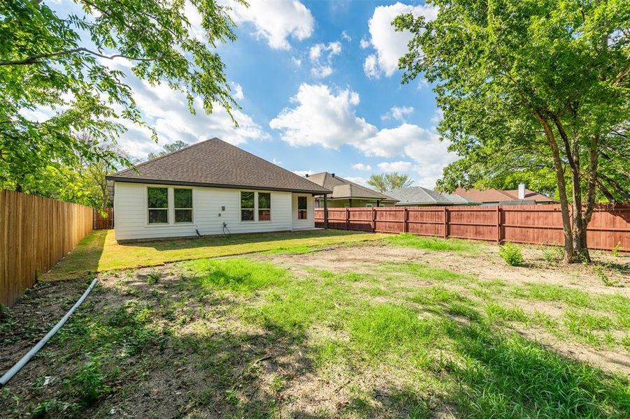 Rear view of property featuring a lawn