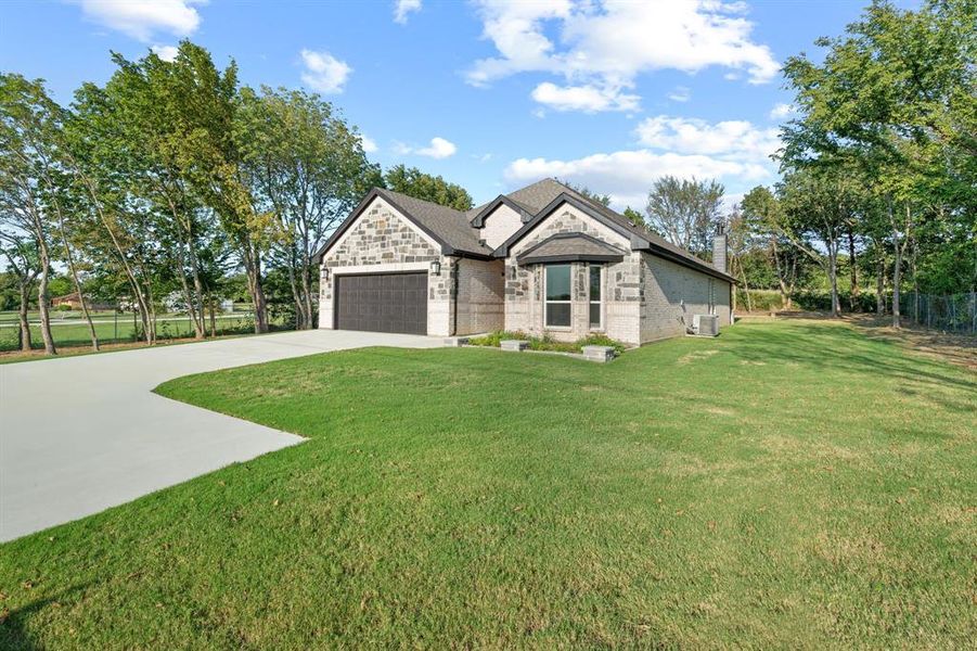 Front exterior of a new home in , Gainesville, TX, highlighting curb appeal (Image 24). Front exterior of a new home in , Gainesville, TX, highlighting curb appeal (Image 24).