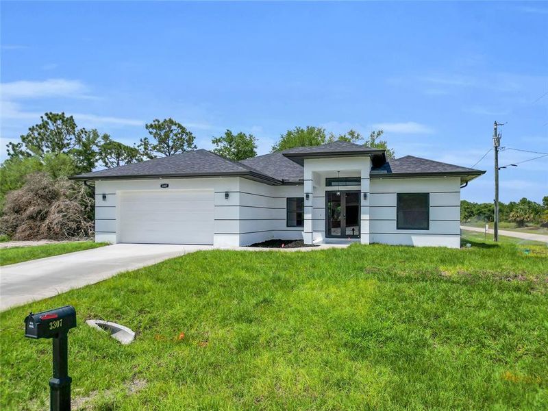 Front exterior of a new home in , Lehigh Acres, FL, highlighting curb appeal (Image 15).