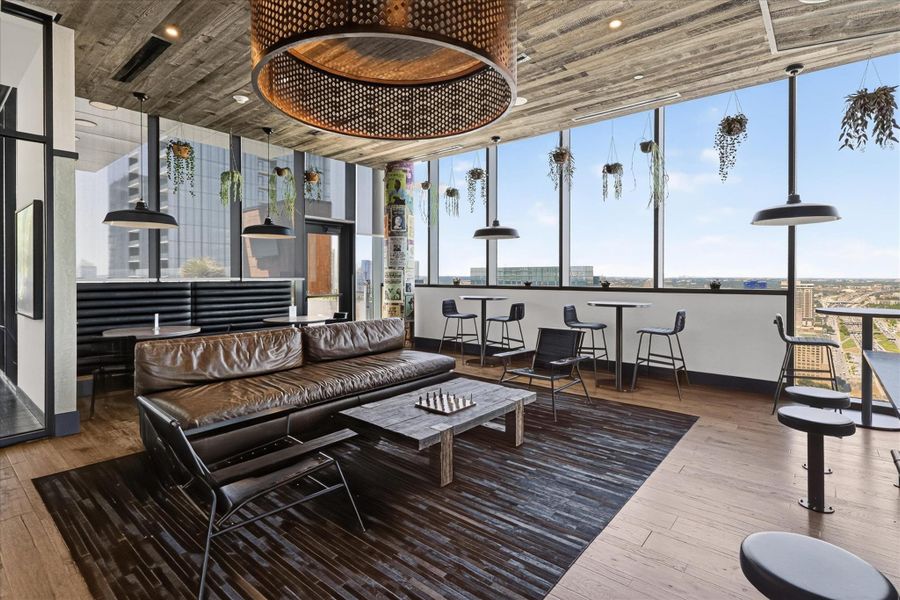 A dynamic lounge space offers city vistas through expansive windows, inviting relaxation and social interaction.