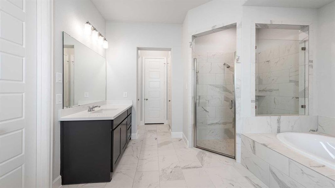 Bathroom featuring vanity and plus walk in shower