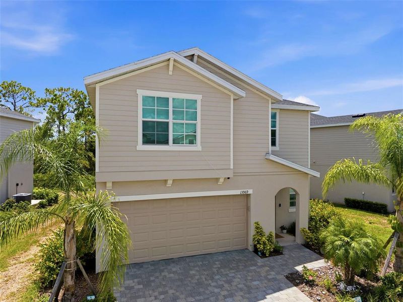 Front exterior of a new home in Aurora at Lakewood Ranch, Bradenton, FL, highlighting curb appeal (Image 2). Front exterior of a new home in Aurora at Lakewood Ranch, Bradenton, FL, highlighting curb appeal (Image 2).