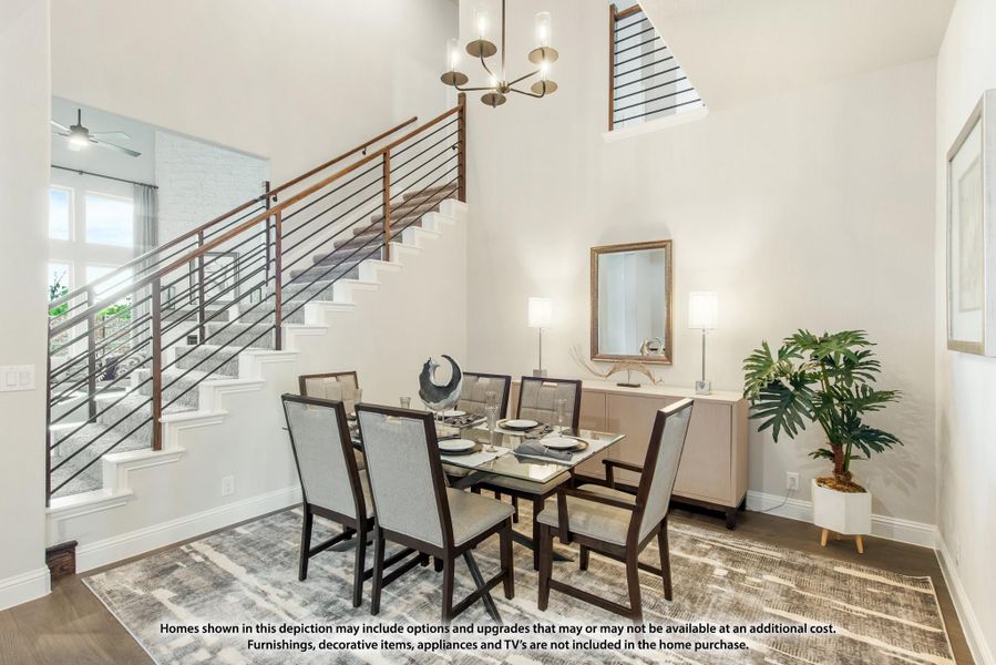 Dining room with high ceilings, glass-top table, six chairs, and open staircase with wood and metal railing