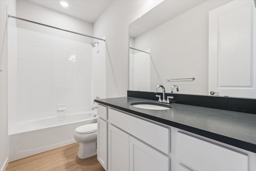 A bathroom with a black countertop.