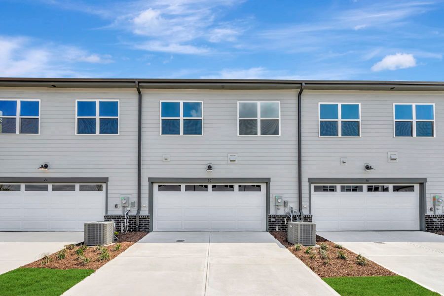Front exterior of a new home in The Townes at NoVi, Pittsboro, NC, highlighting curb appeal (Image 16). Front exterior of a new home in The Townes at NoVi, Pittsboro, NC, highlighting curb appeal (Image 16).