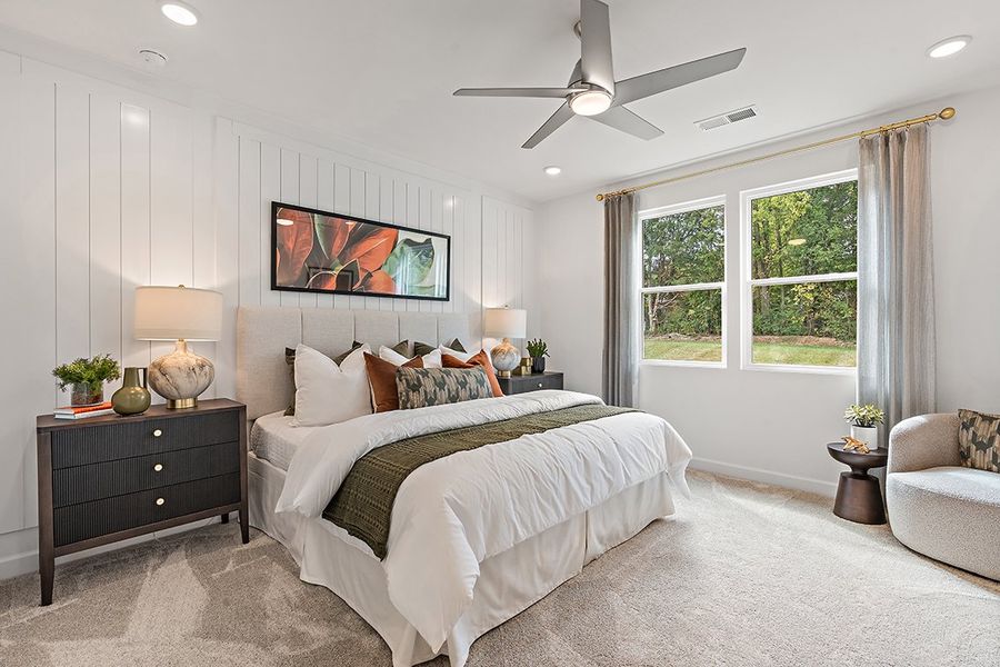 A bedroom with a bed and a fan.