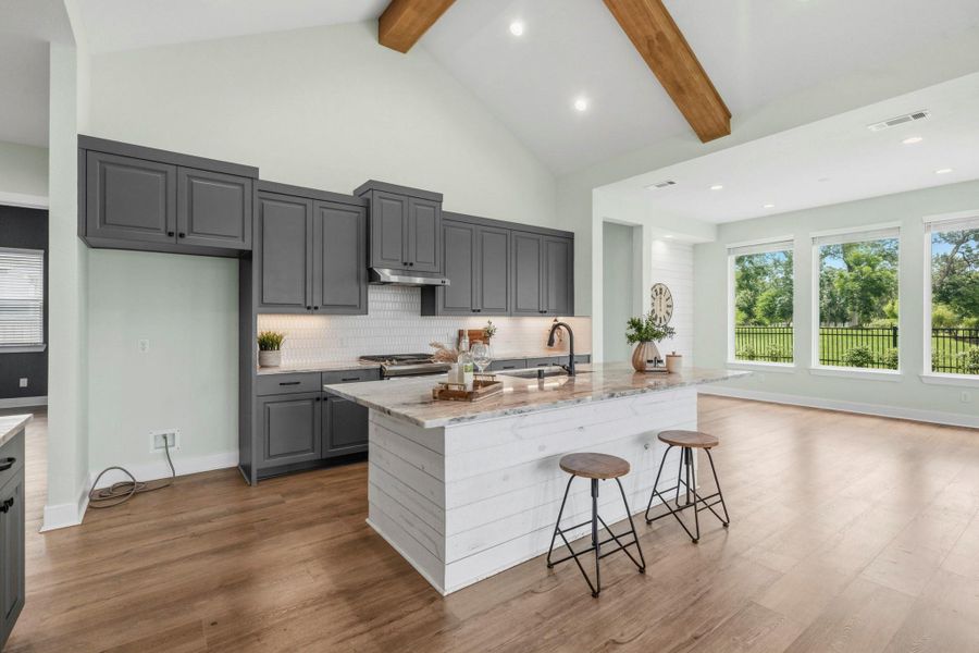 The Kitchen Island boasts generous closed storage, a whisper quiet dishwasher, and a spacious countertop overhang. This versatile gathering spot offers additional seating for casual breakfasts, decorating holiday cookies, helping with homework, or sampling a favorite recipe, making it the true heart of the Kitchen where everyday moments naturally come together.