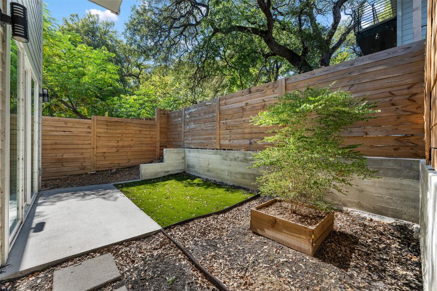 Fenced backyard with a patio