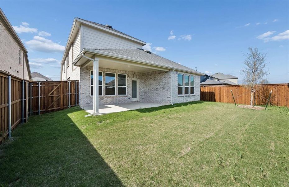 Covered patio with spacious backyard