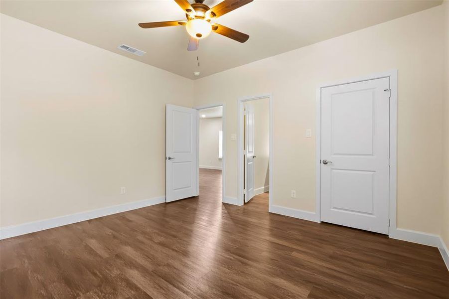 Unfurnished bedroom featuring dark hardwood / wood-style floors