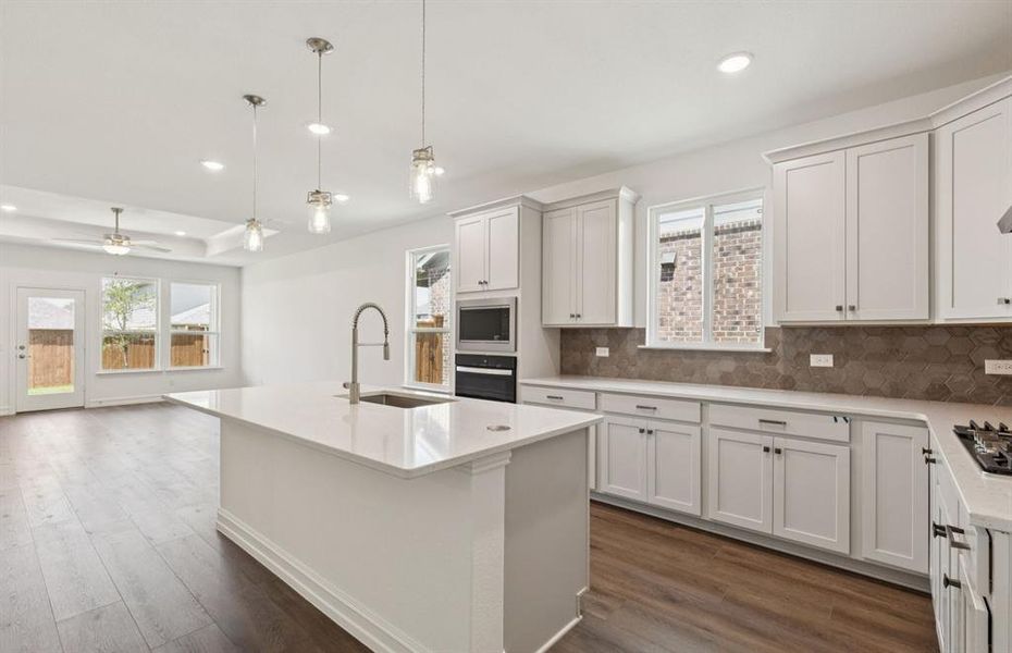 Spacious eat-in kitchen designed with a large island for dining *Real home pictured Spacious eat-in kitchen designed with a large island for dining *Real home pictured